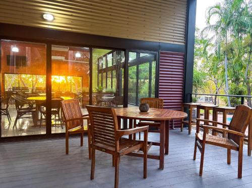 a dining room with a table and chairs on a patio at Breeze Holiday Parks - Mary River in Marrakai