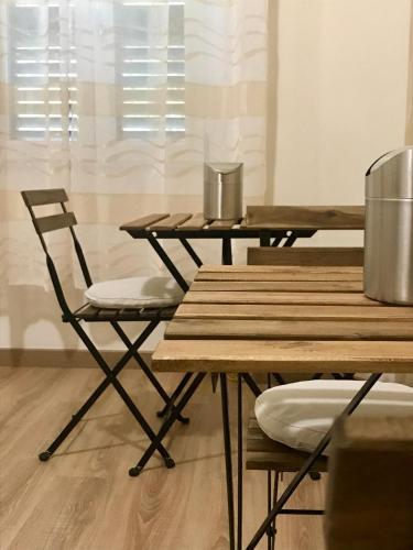 two wooden tables and a chair in a room at B&B Ciocca in Campobasso
