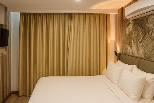 a bedroom with a large bed with white pillows at Positive Hotel in Arnavutköy