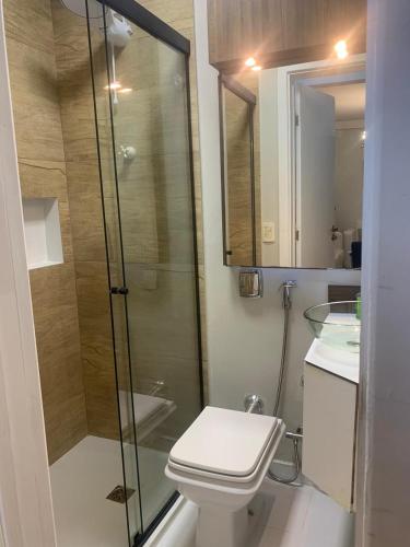 a bathroom with a shower and a toilet and a sink at FamilyHome in Florianópolis