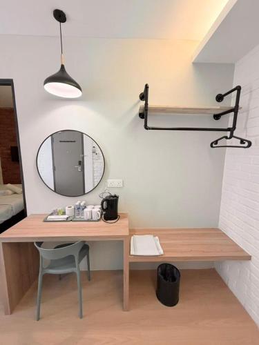 a desk with a mirror and a chair in a room at Mixx Express Hotel Sunway in Petaling Jaya