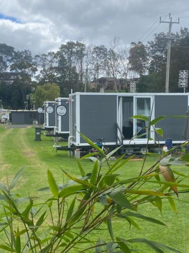 a building that is sitting in the grass at Beachside Bungalows in Batemans Bay