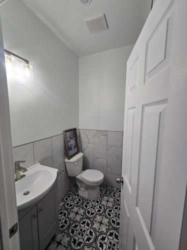 a white bathroom with a sink and a toilet at The Harrison in Harrison