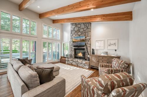 a living room with a couch and a fireplace at Ridge Court # 13 by Tahoe Getaways - 3BR Palisades at Alpine Condo w Ski Shuttle & Tennis! in Alpine Meadows