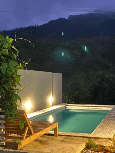 a swimming pool at night with a view at Avons Residence Hanthana in Kandy