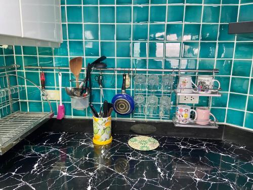 a kitchen with blue tiled walls and a counter top at Amazing Cozy Seaview condo in North Pattaya