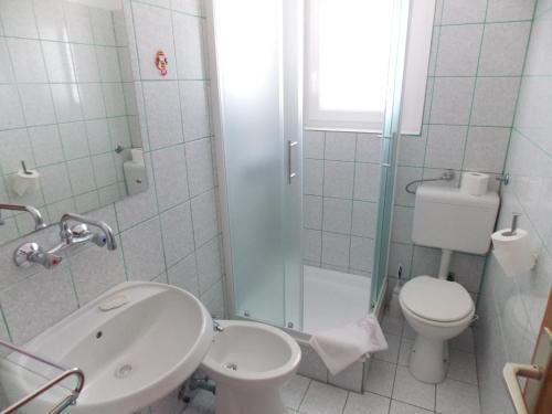 a bathroom with a sink and a toilet and a shower at Double Room Barbat 4862a in Barbat na Rabu