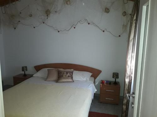 a bedroom with a bed with a pillow on it at Apartment Pomer 7374b in Pomer