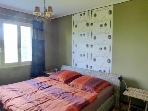 a bedroom with a bed and a wall with numbers on it at Holiday Home in Plozévet near Beaches in Plozévet