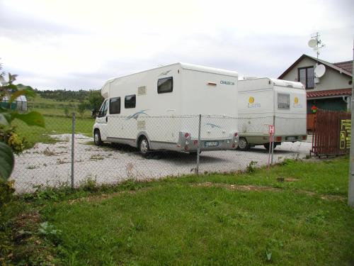 a camper and a trailer parked in a driveway at Penzion Dreveník in Spišské Podhradie