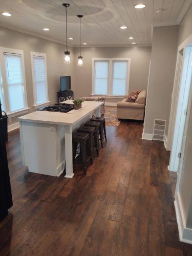 a kitchen with an island with stools in a room at City Getaway in Midland