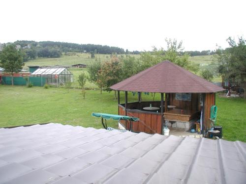a gazebo with a table in a yard at Penzion Dreveník in Spišské Podhradie