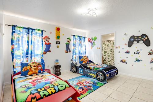 a childs room with two beds and cartoons on the wall at Magical World in Davenport