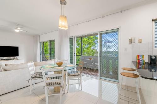 a living room with a couch and a table at Spacious 2-Bed with Private Rooftop & BBQ Access in Brisbane