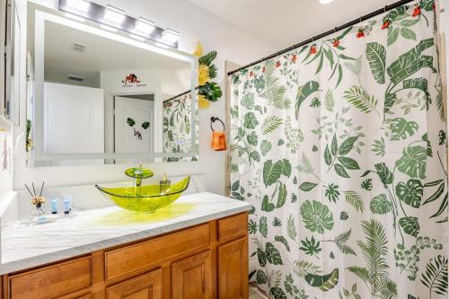 a bathroom with a sink and a shower curtain at Magical World in Davenport