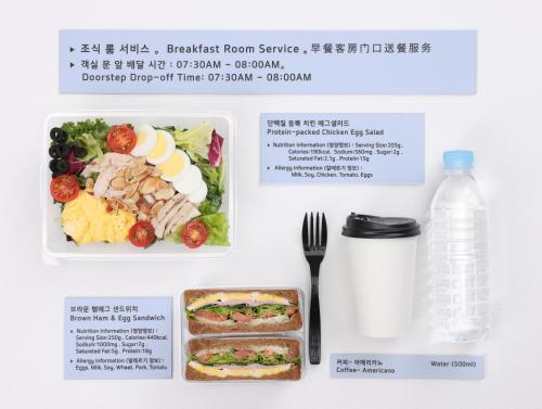 a catalogue of a meal with a fork and a bottle of water at InstaHotel-MainBranch in Suwon