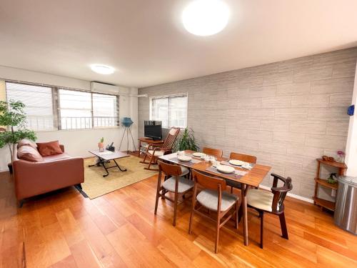 a living room with a table and a couch at お宿 岸ノ四季 in Kishiwada