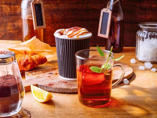 a drink in a glass on a wooden table at ibis Hotel Düsseldorf Hauptbahnhof in Düsseldorf