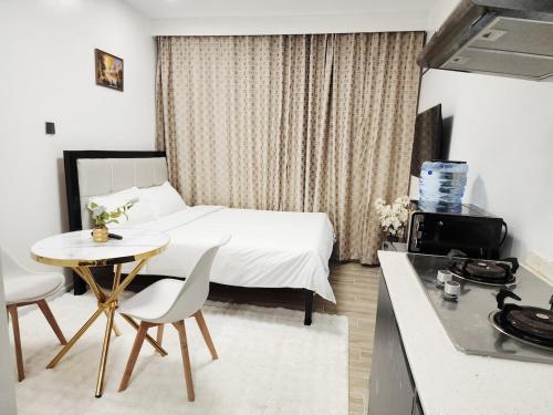 a hotel room with a bed and a table and chairs at Mathel Studio Home in Marimbeti