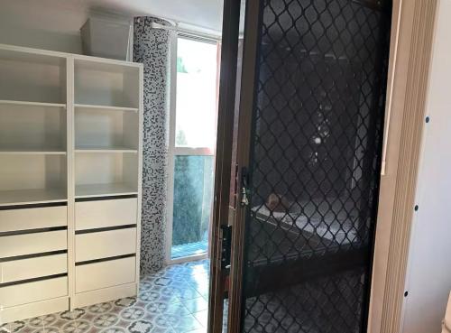 a walk in closet with a glass door at Mains Rd 超大4人带厨房卫浴办公 M1 in Brisbane