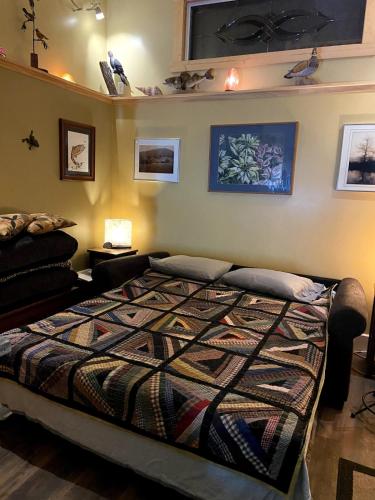 a bedroom with a large bed in a room at Rush River Cottage & Gardens in Ellsworth