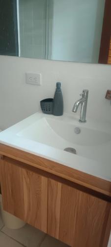 a bathroom counter with a sink and a mirror at Villa Campestre Eagle in Girardot