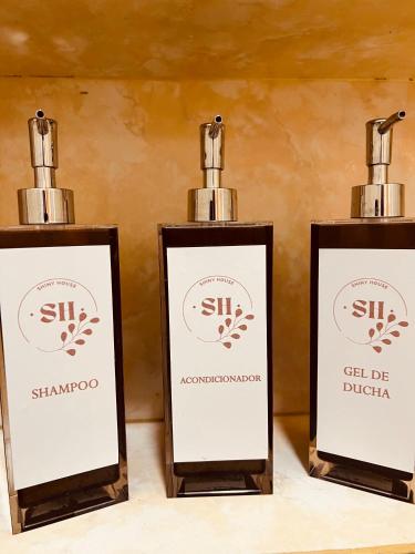 ClorindaにあるSHINY Houseのテーブルの上に置かれたシャンダン化粧品のボトル3本