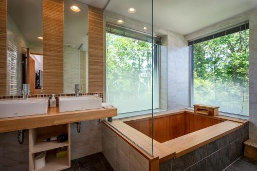 a bathroom with two sinks and a large window at Asobidokoro in Kutchan