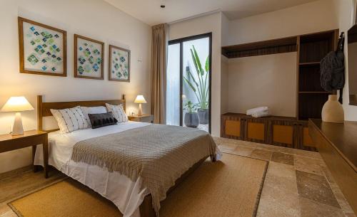 a bedroom with a bed and a large window at Casa KakMo in Izamal