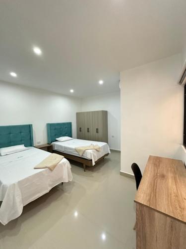 a hospital room with two beds and a table at Hotel Kikos Plaza in Tumbes