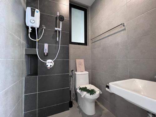 a bathroom with a white toilet and a sink at Georgetown Urban Family & Baby-Friendly Home with Skypool Seaview in Jelutong