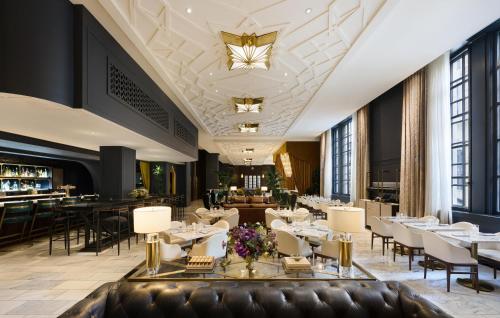 a restaurant with white tables and chairs and a ceiling at The Allegro Royal Sonesta Hotel Chicago Loop in Chicago