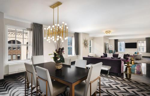 a dining room and living room with a table and chairs at The Allegro Royal Sonesta Hotel Chicago Loop in Chicago