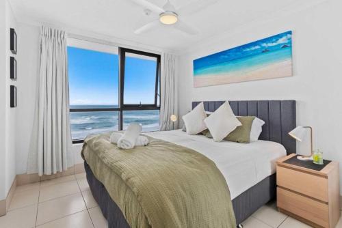 a bedroom with a bed with a view of the ocean at Seascape Serenity in Palm Beach in Gold Coast