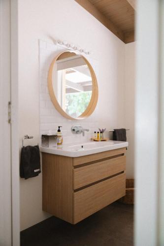 a bathroom with a sink and a mirror at Elevation652 at Mt Bellevue in King Valley in Myrrhee