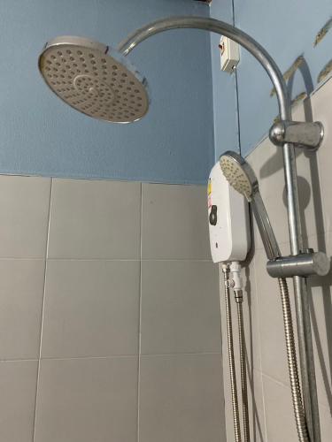 a shower with a shower head in a bathroom at Nadia Resort Kohjum in Ko Jum