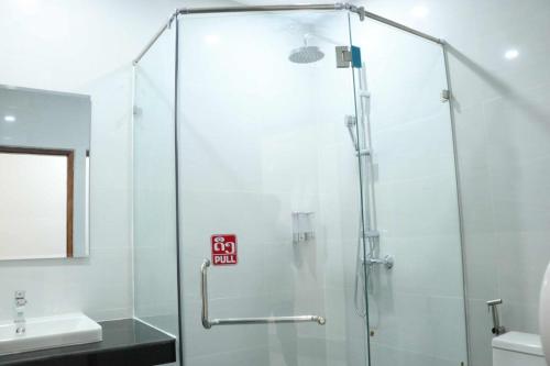 a shower with a glass door in a bathroom at My Luang Prabang Guesthouse in Luang Prabang