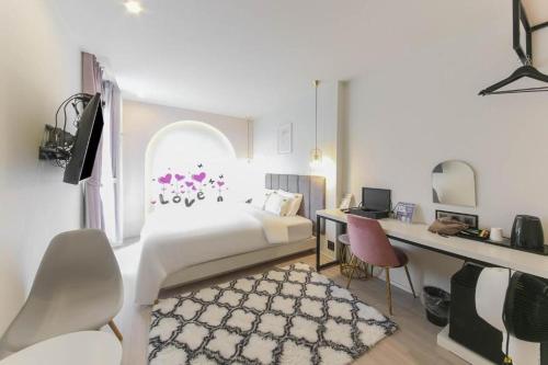 a hotel room with a bed and a desk and a desk at Sasang ND 1226 Hotel in Busan