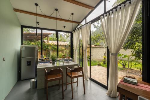 a kitchen and dining room with a table and chairs at Romantic Mirror-Clad Tiny with Private Hot Tub in Pedro Ruiz Gallo