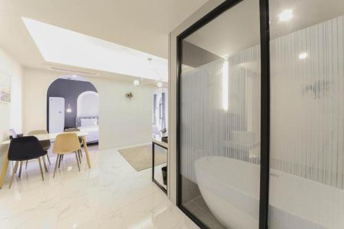 a bathroom with a tub and a dining room at Sasang ND 1226 Hotel in Busan