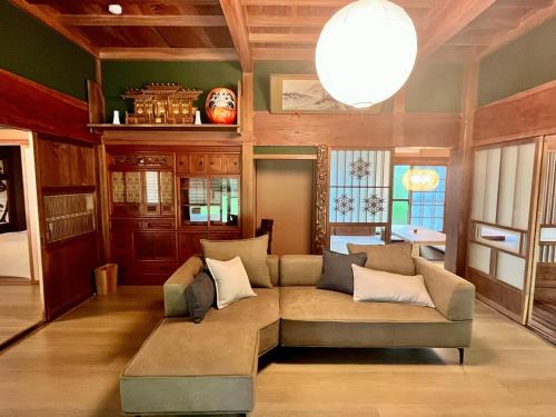 a living room with a couch in a room at Anju KAGUYA 香宮宿 in Katori