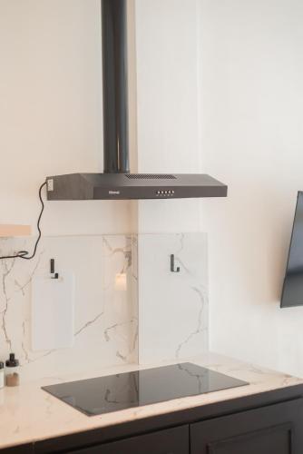 a kitchen with a stove top oven above a counter at CBD Loft Studio 3B, Heart of Multatuli food scene, Walkable, Private compound, High Security in Medan