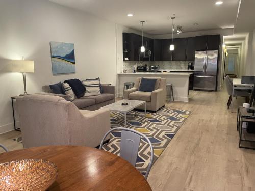 a living room with two couches and a kitchen at Luxe 2BD2BA Townhouse in Hip Area - Near Metro in Washington, D.C.
