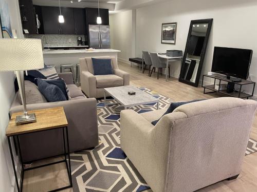 a living room with two couches and a kitchen at Luxe 2BD2BA Townhouse in Hip Area - Near Metro in Washington, D.C.