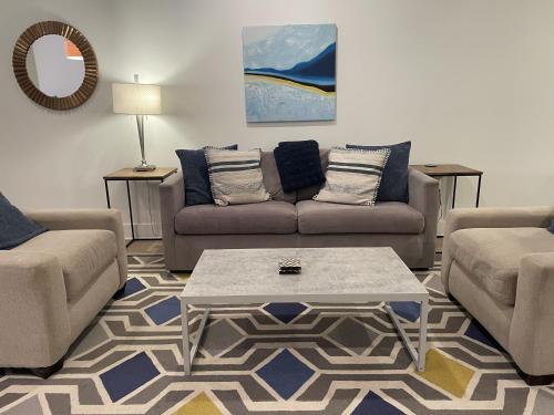 a living room with two couches and a coffee table at Luxe 2BD2BA Townhouse in Hip Area - Near Metro in Washington, D.C.