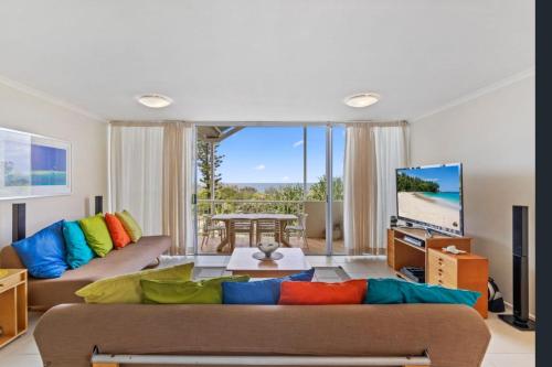 a living room with a couch and a tv at Unit 15 - 45 Lorikeet Drive, Peregian Beach in Peregian Beach