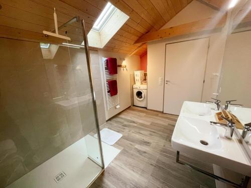 a bathroom with a glass shower and a sink at Gîte à Manthelan : Confort et Charme, Jardin, Wi-Fi - FR-1-381-639 in Monfoué