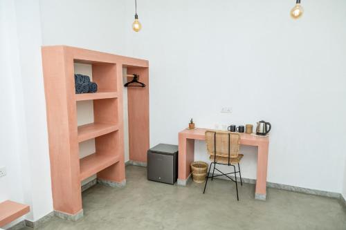 a room with a table and a desk with a chair at Rise - Bed & Breakfast in Weligama