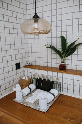 a table with rolls of toilet paper and a potted plant at The Tiing Tejakula Villas in Tejakula