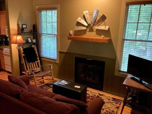 a living room with a couch and a fireplace at Family-Friendly Cabin with Private Hot Tub near Charlotte, North Carolina in Elkin